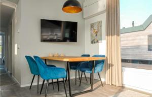 een eetkamer met een houten tafel en blauwe stoelen bij Statendam 12 Oh Laak in Ohé en Laak