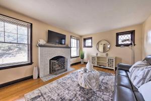 a living room with a fireplace and a tv at St Louis Vacation Rental 4 Mi to Airport! in Woodson Terrace