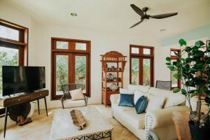 a living room with a couch and a flat screen tv at Castle Shore in Catmon