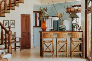 a kitchen with a table and chairs in a room at Castle Shore in Catmon
