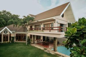 a large house with a balcony and a yard at Castle Shore in Catmon