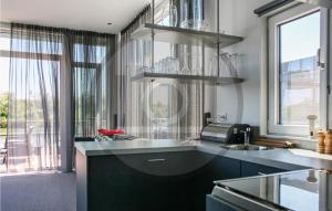 a kitchen with a sink and a counter top at Houseboat Waterlelie in Ohé en Laak