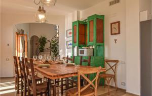 a dining room with a wooden table and chairs at Cozy Home In Ragusa With Outdoor Swimming Pool in Ragusa