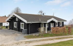 a black house with white windows and a driveway at 3 Bedroom Gorgeous Home In Hasle in Hasle