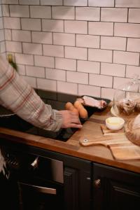 a person preparing food on a counter in a kitchen at Way Out Wandi in Wandiligong