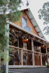 a house with vines growing up the side of it at Way Out Wandi in Wandiligong