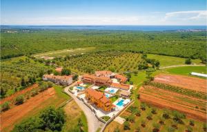an aerial view of a house in a field at Awesome Home In Hr-52215 Vodnjan With House Sea View in Vodnjan