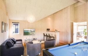 a living room with a pool table at Cozy Home In Vejby With Indoor Swimming Pool in Vejby