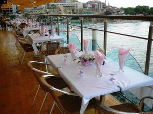 a table on a cruise ship with tables and chairs at Hotel Parnasse in Sozopol