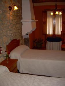 Łóżko lub łóżka w pokoju w obiekcie Casa Rural el Castellet