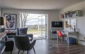 a living room with a table and chairs and a desk at Beautiful Apartment In Allinge With House Sea View in Allinge