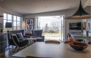 a living room with a table and chairs at Beautiful Apartment In Allinge With House Sea View in Allinge