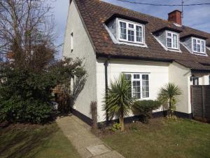 a white house with a brown roof at Crow Corner in Yoxford