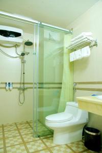 a bathroom with a shower and a toilet and a sink at Hotel Sao Xanh in Sa Pa
