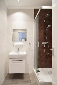 a white bathroom with a sink and a shower at Hamburg-App-06 in Ahlbeck