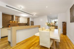 a kitchen and dining room with a table and chairs at Cottesloe Beach Haven in Perth