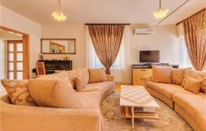 a living room with two couches and a tv at Gorgeous Home In Bribir With Outdoor Swimming Pool in Bribir