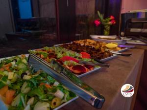 a buffet with several plates of food on a table at LVIS Village in Dharavandhoo