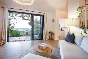 a living room with a couch and a table at The Lookout, Eagle Bay in Dunsborough