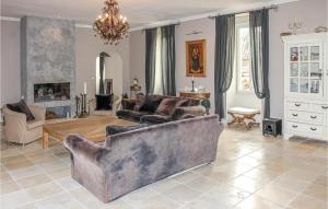 a living room with a couch and a table at Stunning Home In Pont Saint Esprit With Kitchen in Pont-Saint-Esprit