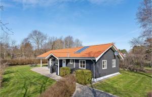 a small house with an orange roof on a yard at Stunning Home In Vejby With 3 Bedrooms And Wifi in Vejby