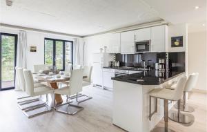 a kitchen and dining room with a table and chairs at Captn in Binz