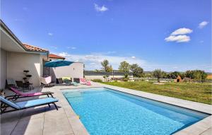 einen Pool mit 2 Stühlen und einem Sonnenschirm in der Unterkunft Awesome Home In Pont-vque With Private Swimming Pool, Can Be Inside Or Outside in Pont-Évêque