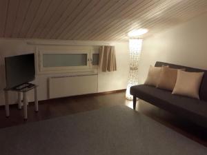 a living room with a couch and a television at Apartment Marta in Vuokatti