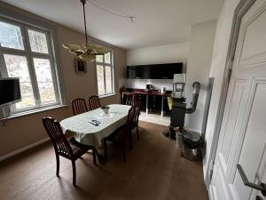 a kitchen and dining room with a table and chairs at Bahnhof Paulinzella mit Sauna in Königsee