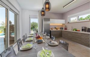a kitchen and dining room with a table and chairs at Luxurious Home In Stinjan in Štinjan
