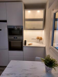 a kitchen with a stove and a counter top at Las Tres Mimosas in San Vicente de la Barquera +42 photos