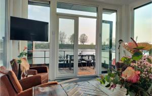 a living room with sliding glass doors and a television at Beautiful Ship-boat In Oh Laak With Wifi And 2 Bedrooms in Ohé en Laak