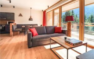 a living room with a couch and a table at Stunning Apartment In Flachau With 1 Bedrooms And Wifi in Flachau