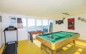 a room with a pool table and a balcony at Stunning Home In Brsecine With Outdoor Swimming Pool in Brsečine