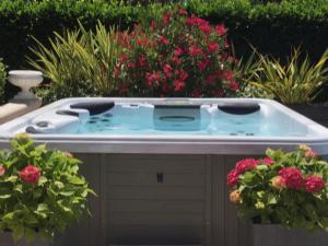 a hot tub in a garden with flowers at Lavish Villa in Mouans Sartoux with Sauna in Mouans-Sartoux