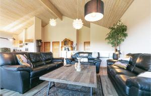 a living room with leather couches and a coffee table at Alpehuset in Allinge