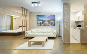 a living room with a couch and a bed at The ONE Apart Hotel Luxury Suites & Apartments in Skopje