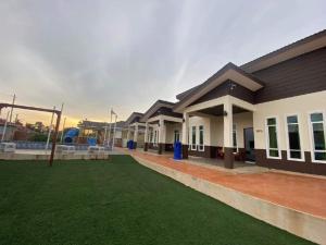 a building with a playground in front of it at Aja Retreat Chalet in Jitra