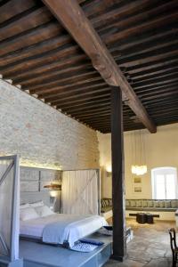 a bedroom with a large bed with a wooden ceiling at Keresbino Hydra Manor House in Hydra