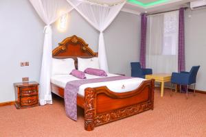 a bedroom with a canopy bed with purple pillows at Sheratton Beach Villagio in Mombasa