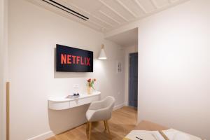 a white desk with a chair in a room at αυλή Ναύπλιον in Nafplio