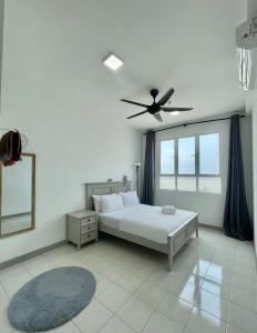 a bedroom with a bed and a ceiling fan at KiRA Drawbridge Homestay with pool WIFI NETFLIX near KTCC Mall in Kuala Terengganu