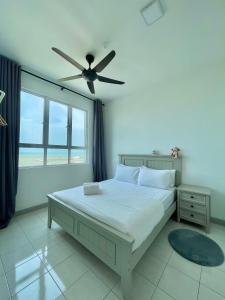 a bedroom with a bed with a ceiling fan at KiRA Drawbridge Homestay with pool WIFI NETFLIX near KTCC Mall in Kuala Terengganu