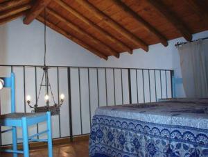 a bedroom with a bed and a table and a chandelier at Residence il Baglio in Porto San Giorgio