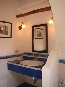 a bathroom with a sink and a mirror at Residence il Baglio in Porto San Giorgio
