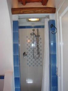 a bathroom with a shower with blue tiles at Residence il Baglio in Porto San Giorgio +44 photos