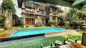 a swimming pool in the yard of a house at Above The Sea Maesariang in Mae Sariang