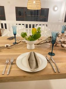 a table with a plate with a napkin on it at Imasiku House in Southbroom +18 photos