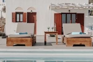 a room with two chairs and a table and a pool at Villa of Roses in Naxos - Private villa with pool in Naxos Chora