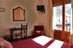 Ένα ή περισσότερα κρεβάτια σε δωμάτιο στο Hotel Garona